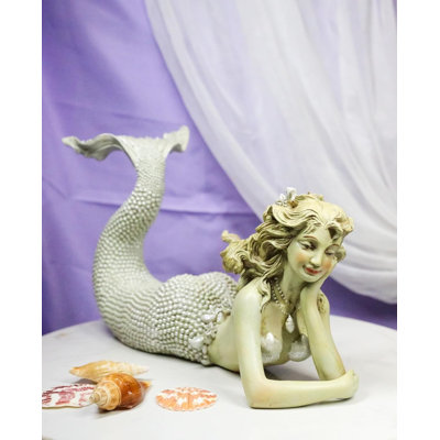 Figurine nautique marine sirène nacrée allongée sur le ventre