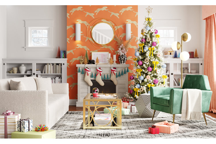 Christmas tree with orange and purple round ornaments next to an orange accent chair with purple pillow