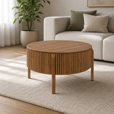 Round walnut coffee table with vertical slat detailing and hidden storage; solid wood centerpiece for a farmhouse-style living room.