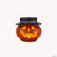 Bol à bonbons citrouille d'Halloween avec chapeau de sorcière et lanterne lumineuse