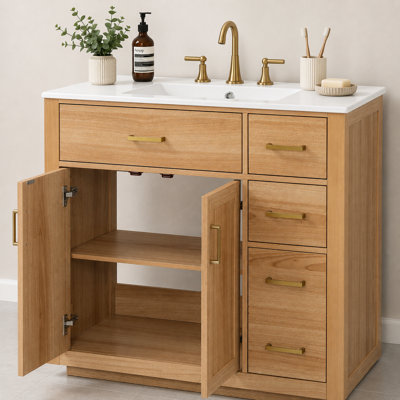 35.8-inch natural wood-tone vanity with ceramic sink; solid rubberwood frame; features soft-close double doors and four storage drawers.