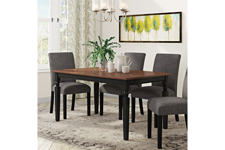 Traditional wood dining table with black table legs.