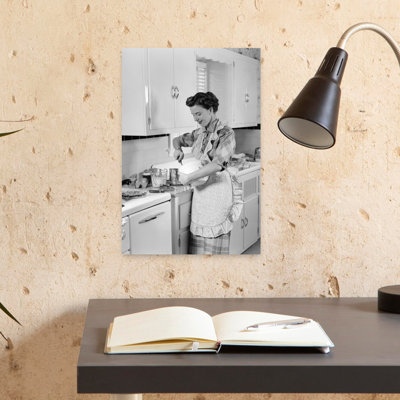 1950s WOMAN HOUSEWIFE IN KITCHEN APRON MIXING BAKING INGREDIENTS IN BOWL by H. Armstrong Roberts - Wrapped Canvas Print