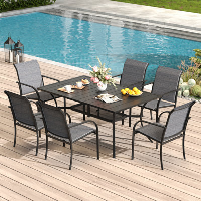 Cihangir Rectangular 6 - Person 60'' L Outdoor Patio Dining Set with 6 Stackable PVC-coated polyester Armrest Chairs