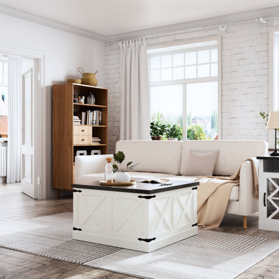 Table basse carrée blanche avec deux plateaux relevables et un espace de rangement spacieux pour les couvertures