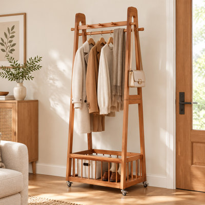 Portant à vêtements en bois massif avec roulettes verrouillables, double tringle, crochets latéraux et panier de rangement inférieur, portant autoportant, organisateur de vêtements à roulettes pour chambre ou entrée.