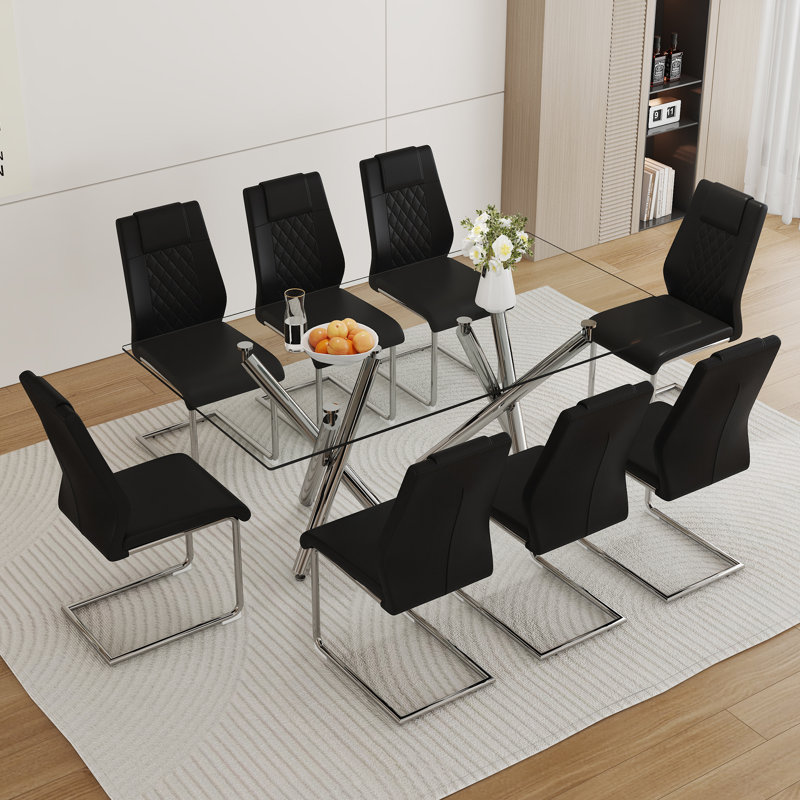 Ensemble de table de salle à manger moderne et luxueux en verre transparent avec 8 chaises - pieds en métal argenté et sièges en cuir PU noir
