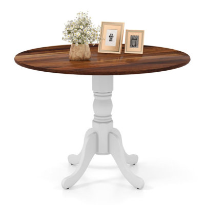 Table de salle à manger en bois avec plateau rond et pieds en tréteaux courbés