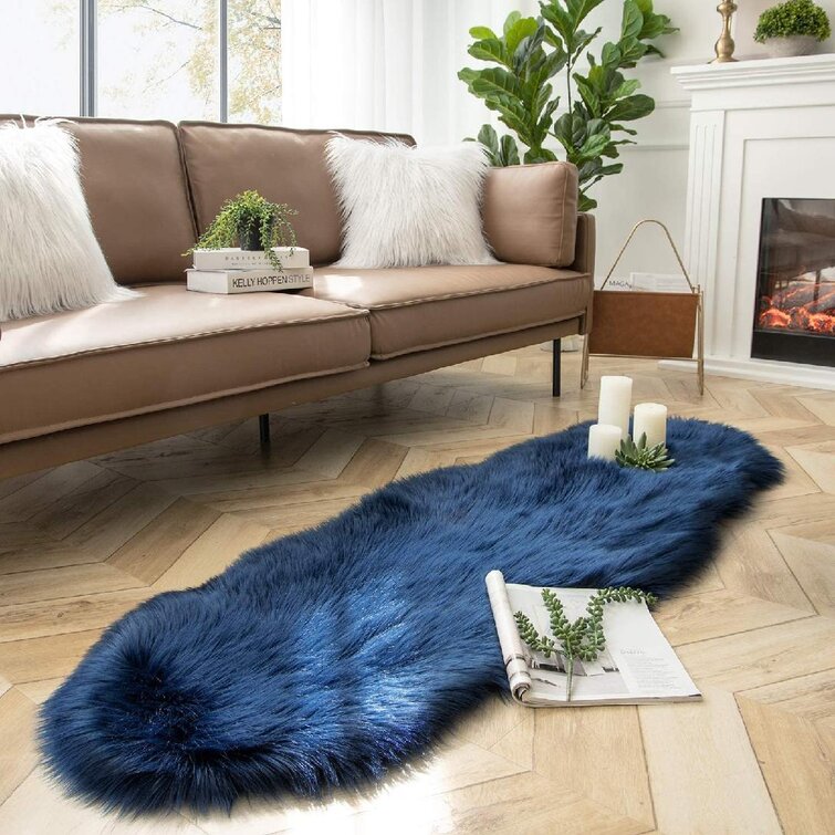 https://assets.wfcdn.com/im/23761356/resize-h755-w755%5Ecompr-r85/1695/169505919/Estere+Faux+Sheepskin+Rug.jpg