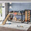 Lit mezzanine / lit superposé simple en métal de taille XL avec panier de basketball, anneaux de traction, mur d'escalade et étagères intégrées. Conception ludique pour enfants avec glissade