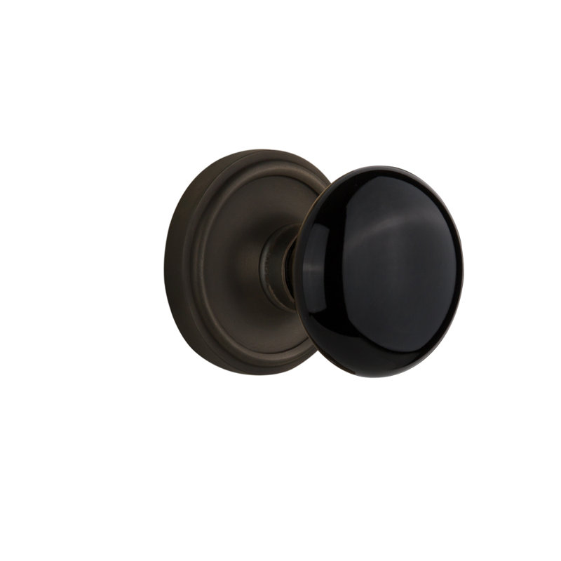 Rosette Nostalgic Warehouse Classic avec bouton de porte en porcelaine noire, 2,375 po, Bronze frotté à l'huile