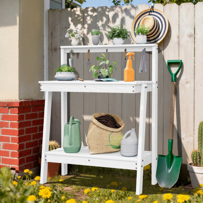 45,5 po X l 34,8 po X P 17,7 po D Table de rempotage en PEHD, plante polyvalente et tablette de rangement