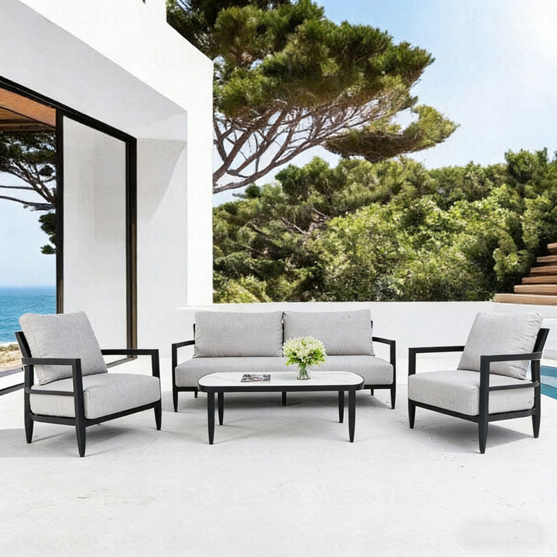 Ensemble de conversation extérieur 4 pièces avec fauteuils club modernes, canapé luxueux avec banc, table basse en pierre frittée d'inspiration marbre, structure en aluminium noir antirouille Ember et coussins Sunbrella