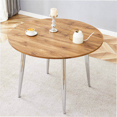Doté d'un mécanisme rétractable intelligent, le plateau de table en panneau de fibres à densité moyenne Wood Grain et les pieds en métal argenté offrent une surface lisse et délicate. Le look unique crée la silhouette élégante d'une maison moderne.