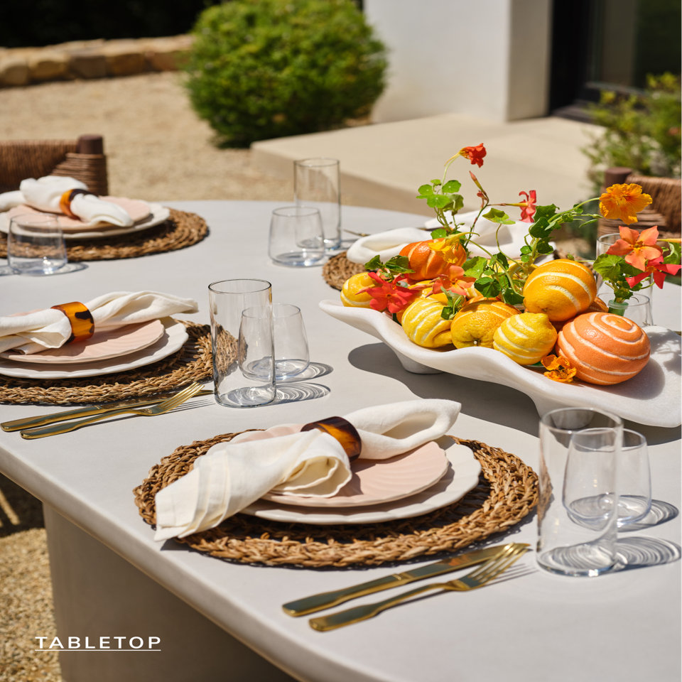 Tabletop setting with decorative citrus centerpiece.
