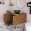 Meuble-lavabo mural 30 po couleur grain de bois espresso, comptoir en pierre frittée noire et cuve en céramique noire.