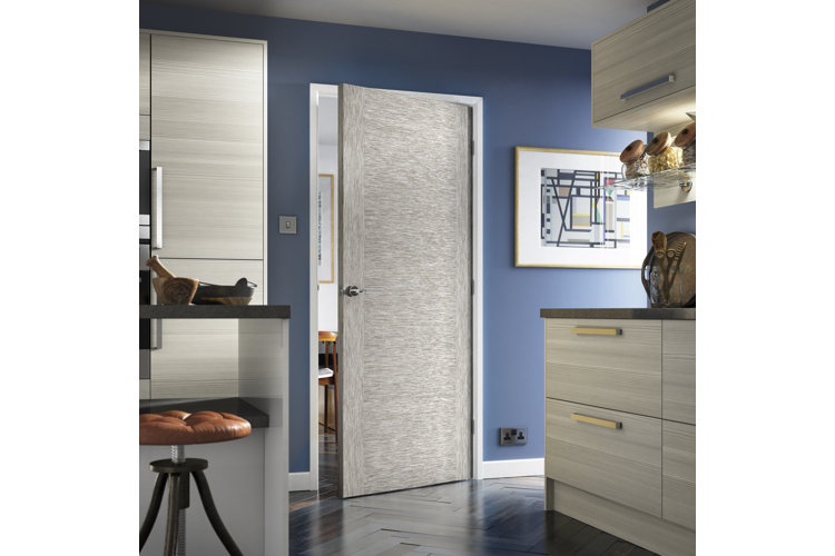 Kitchen with gray cabinets and a gray hinged door and blue walls
