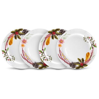 Set of four decorated ceramic appetiser plates on a white background