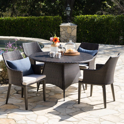 Backlund 4 - Person Wicker Patio Dining Set with Round Table , Cushions Included