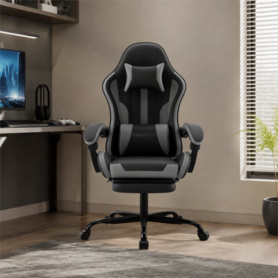 Black and gray ergonomic gaming chair with footrest, lumbar support, and headrest, height adjustable, and 360° swivel, suitable for both office and gaming use.