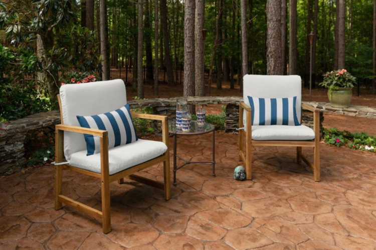 two patio chairs with white Sunbrella® cushions and blue striped pillows