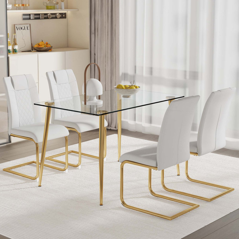 Ensemble de table et de chaises. Table de salle à manger rectangulaire avec plateau en verre trempé et pieds en métal plaqué. Avec 4 chaises avec pieds en métal