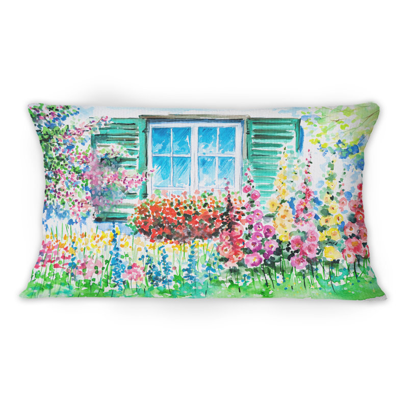 Coussin rouge imprimé géranium rouge devant une fenêtre bleue