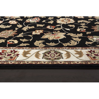 Tapis persan noir à motif floral
