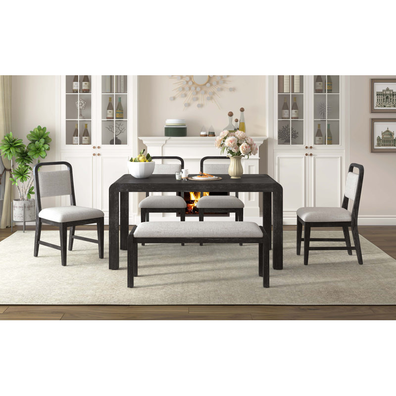 Ensemble de salle à manger extensible 6 pièces avec chaises rembourrées et banc pour une utilisation polyvalente et peu encombrante.