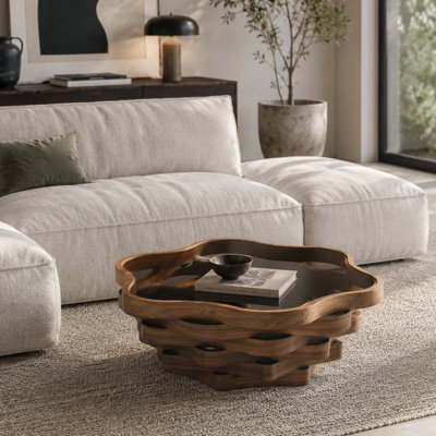 Table basse moderne en forme de nuage avec plateau en verre et base ondulée pour le décor du salon