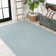 Tapis intérieur / extérieur à chevrons concentriques carrés turquoise / gris clair