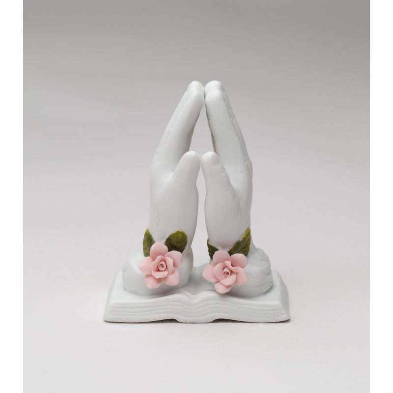 Figurine priant avec une rose