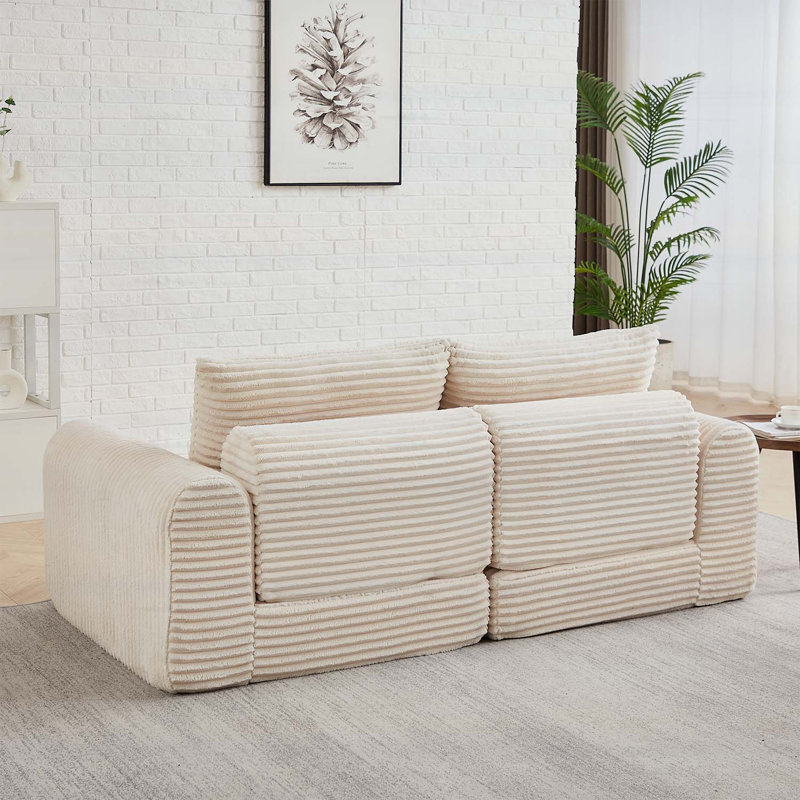 Canapé minimaliste en velours côtelé avec lignes courbes et dossier légèrement incliné, canapé 2 en 1 et lit, comprend deux coussins décoratifs
