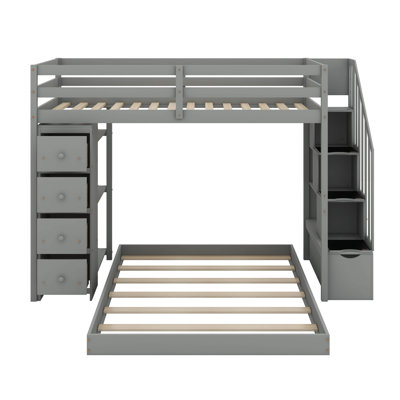 Lit simple superposé au dessus d'un lit double avec tablettes, tiroirs et escaliers