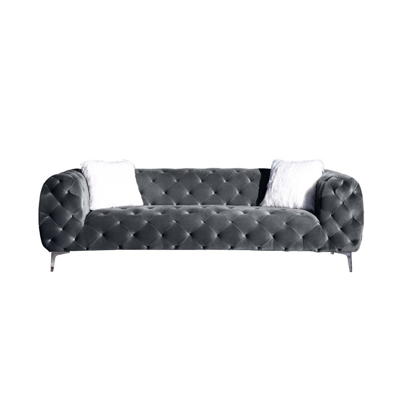 Élégant canapé de salon en velours avec capitonnage et repose-pieds, idéal pour créer un environnement luxueux et confortable
