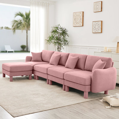 Tissu bouclé rose à 4 places en forme de L convertible, en forme de coquillage et amovible. Les pieds cylindriques de conception moderne pour un canapé modulaire à domicile confortable offrent un style confortable