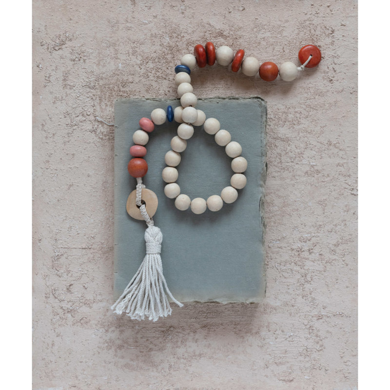 Guirlande de perles en bois avec pampille en coton