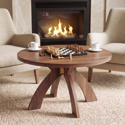 Table basse ronde moderne en bois avec pieds croisés courbés