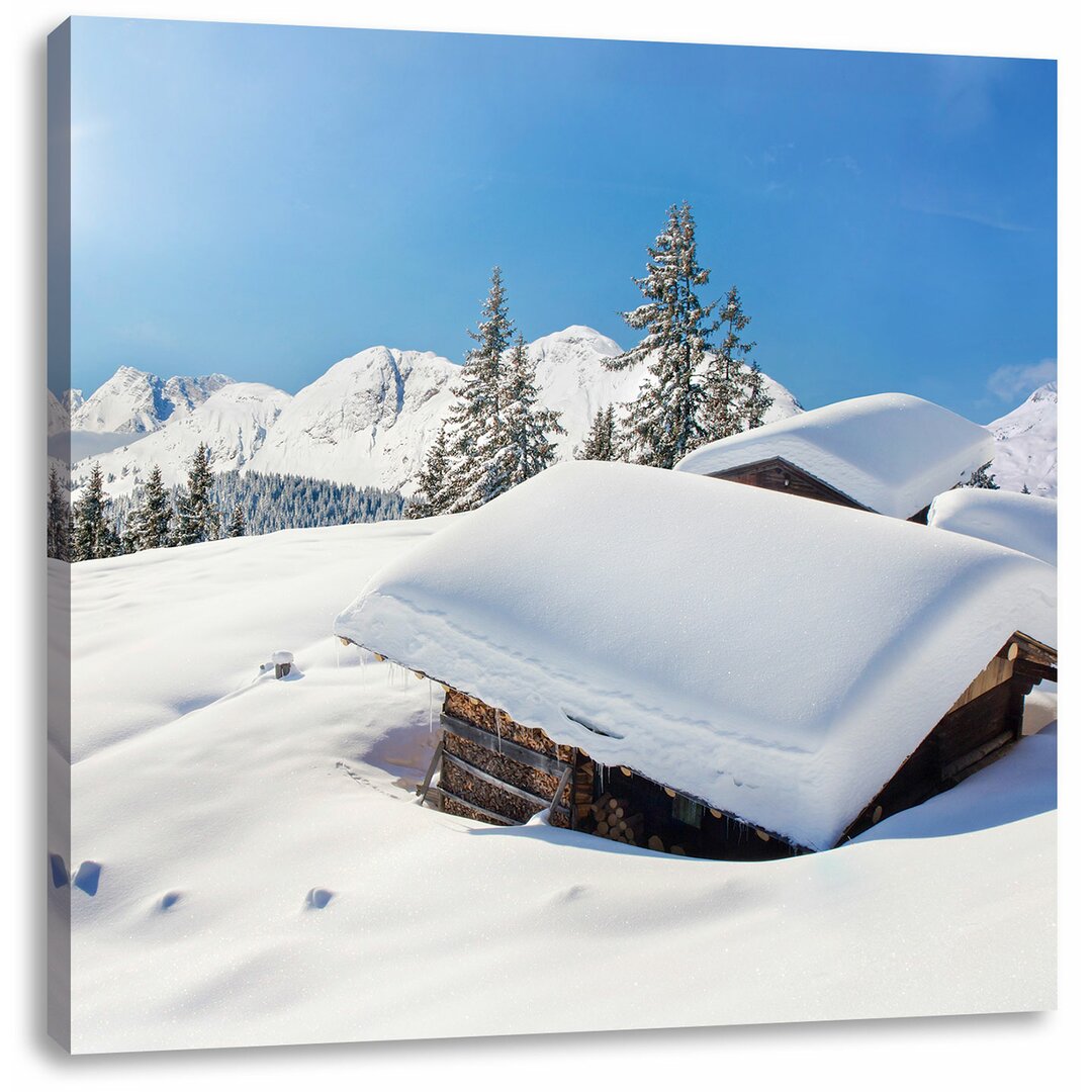 Leinwandbild Verschneite Berghütten in den Alpen