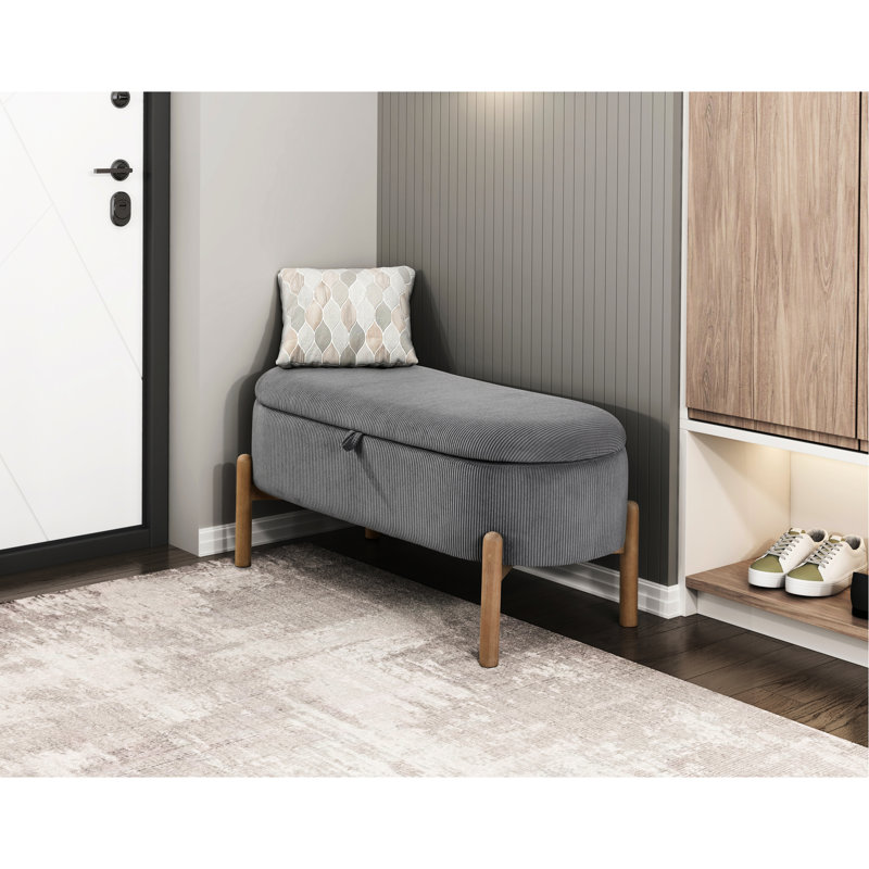 Banc de rangement élégant en velours côtelé gris avec des pieds en bois massif et une base polyvalente d'inspiration Mid-Century