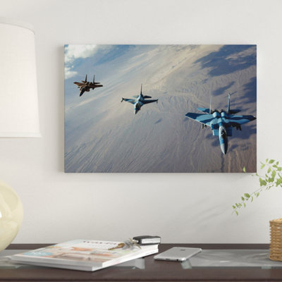 " F-15 Eagles And A F-16 Fighting Falcon Fly In Formation " by Stocktrek Images