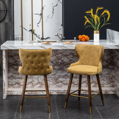 Mid-Century Modern Counter Stool In Yellow - Faux Leather , Seat, Walnut Legs, Gold Metal Footrest With Trim Mid-Century Suede-Like Fabric, Nailhead Trim, Solid Wood Legs