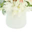 Papillons magnolia et pampas assortis disposés dans un vase en verre