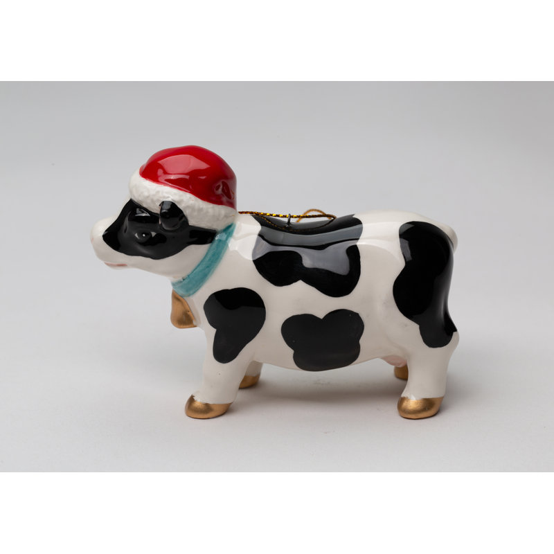 Vache portant un ornement de Noël suspendu à un chapeau de Noël