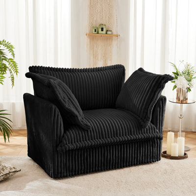 A Comfortable Single-person Sofa Equipped With One Large Cushion And Two Small Pillows by Marina Surf Eshop