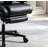 This black high-back leather ergonomic chair features an adjustable headrest, lumbar support, and extendable footrest, allowing for reclining and making it suitable for home, office, and gaming use.