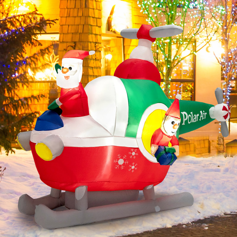 Grand père Noël volant d'un hélicoptère gonflable