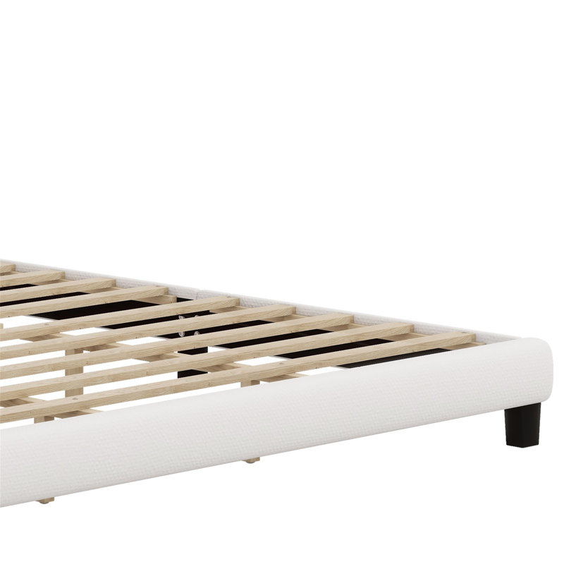 Lit plateforme tapissier avec tête de lit courbée et détails capitonnés
