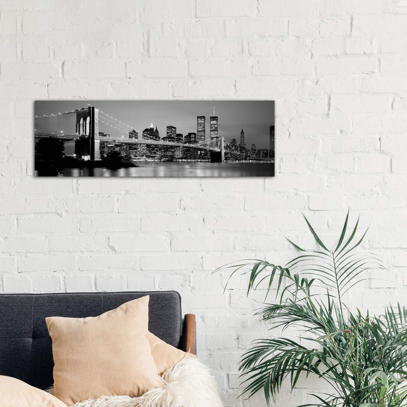 Illuminated Brooklyn Bridge With Lower Manhattan's Financial District Skyline In The Background In B&W, New York City, New York by Panoramic Images - Wrapped Canvas Panoramic Print
