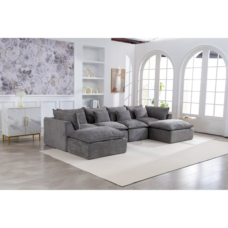 Canapé d'angle modulaire surdimensionné Cloud Couch de 330 cm de large, offrant un confort optimal et une assise large et profonde. Revêtement en tissu gaufré, 4 places avec 2 poufs.